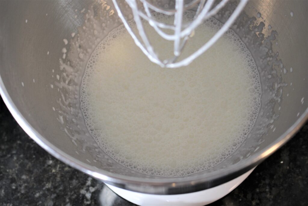 Once the cream gets frothy and bubbly, it's time to add the powdered sugar and vanilla.