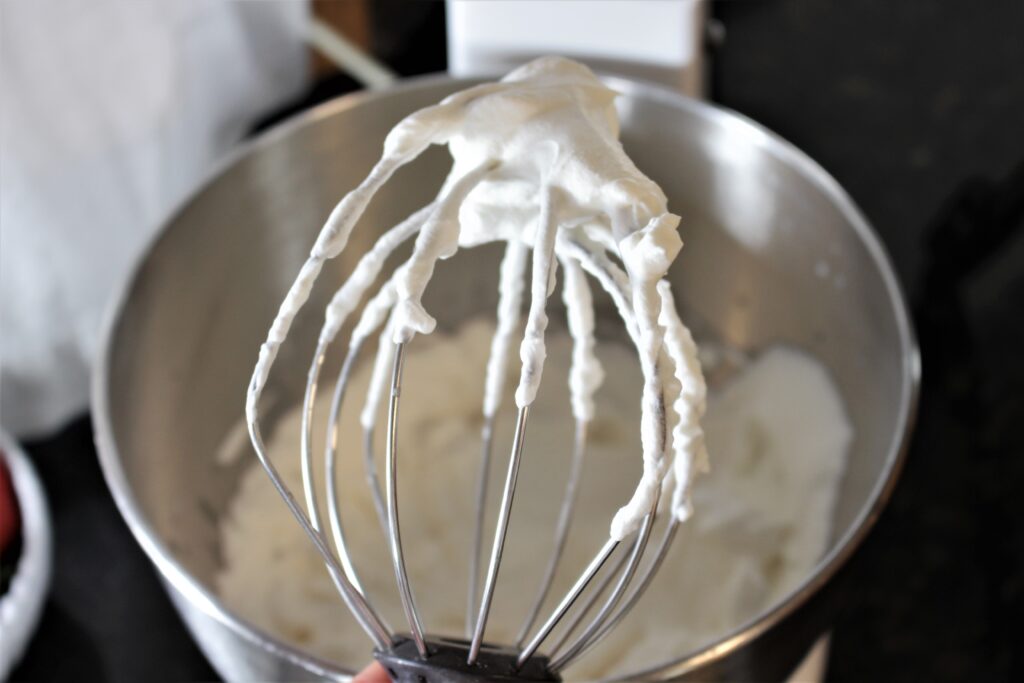 Whipped cream is complete when soft peaks form.