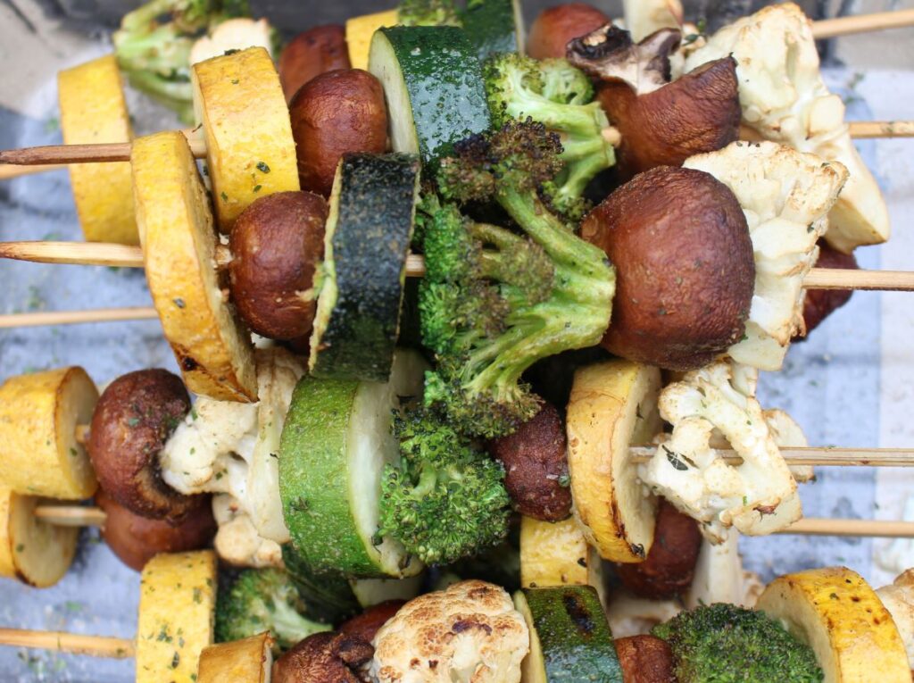 A light char on summer squash, mushrooms, zucchini, broccoli, and cauliflower seasoned and smoked on skewers.
