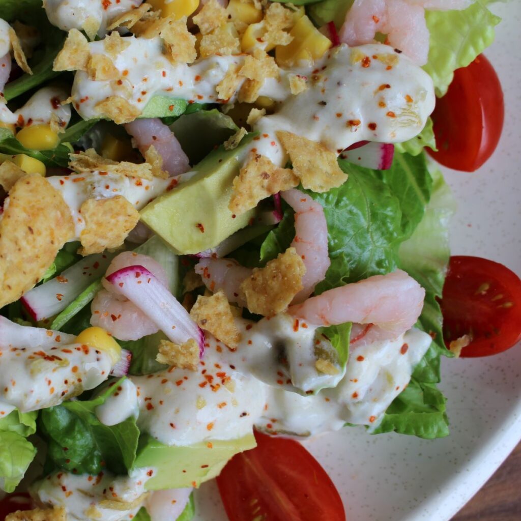 Close up of Tex Mex Salad topped with crunchy tortilla chips.