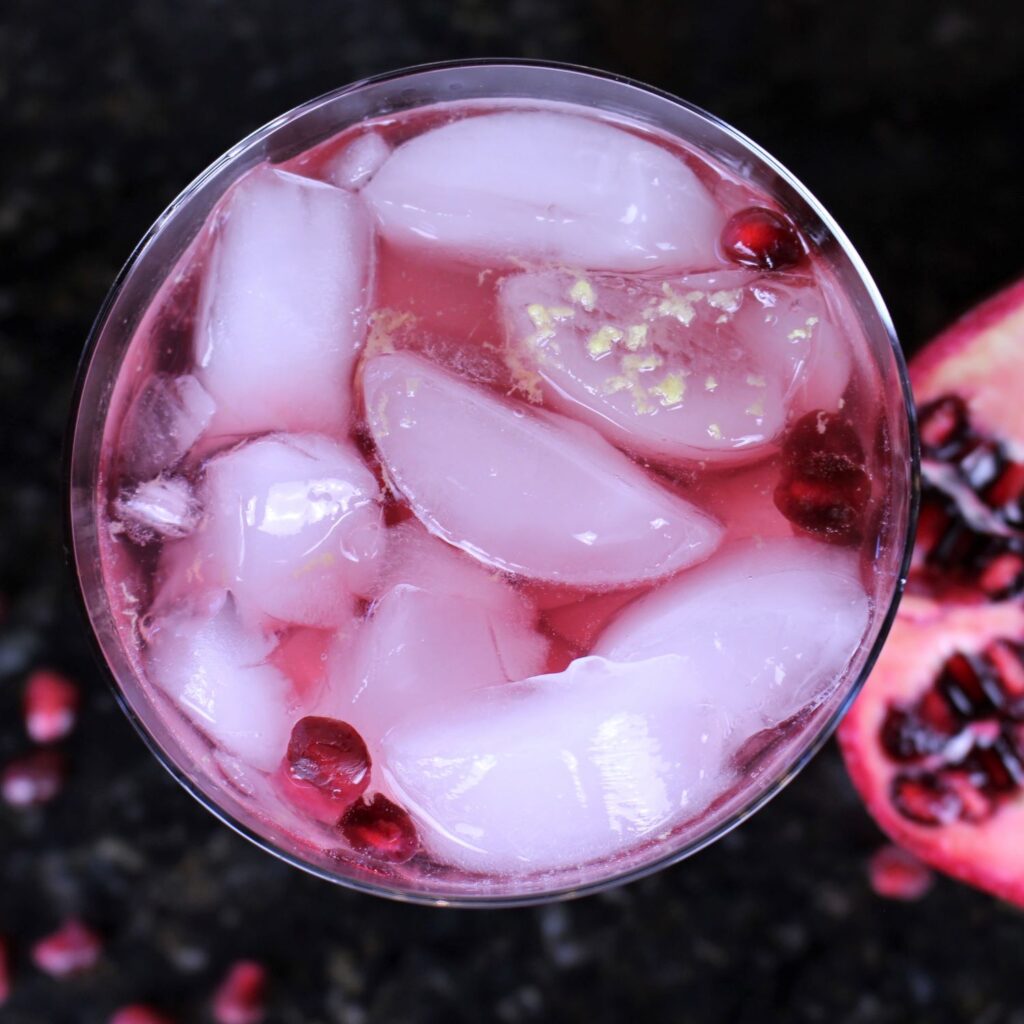 Grated ginger on top of pomegranate gin & ginger fizz