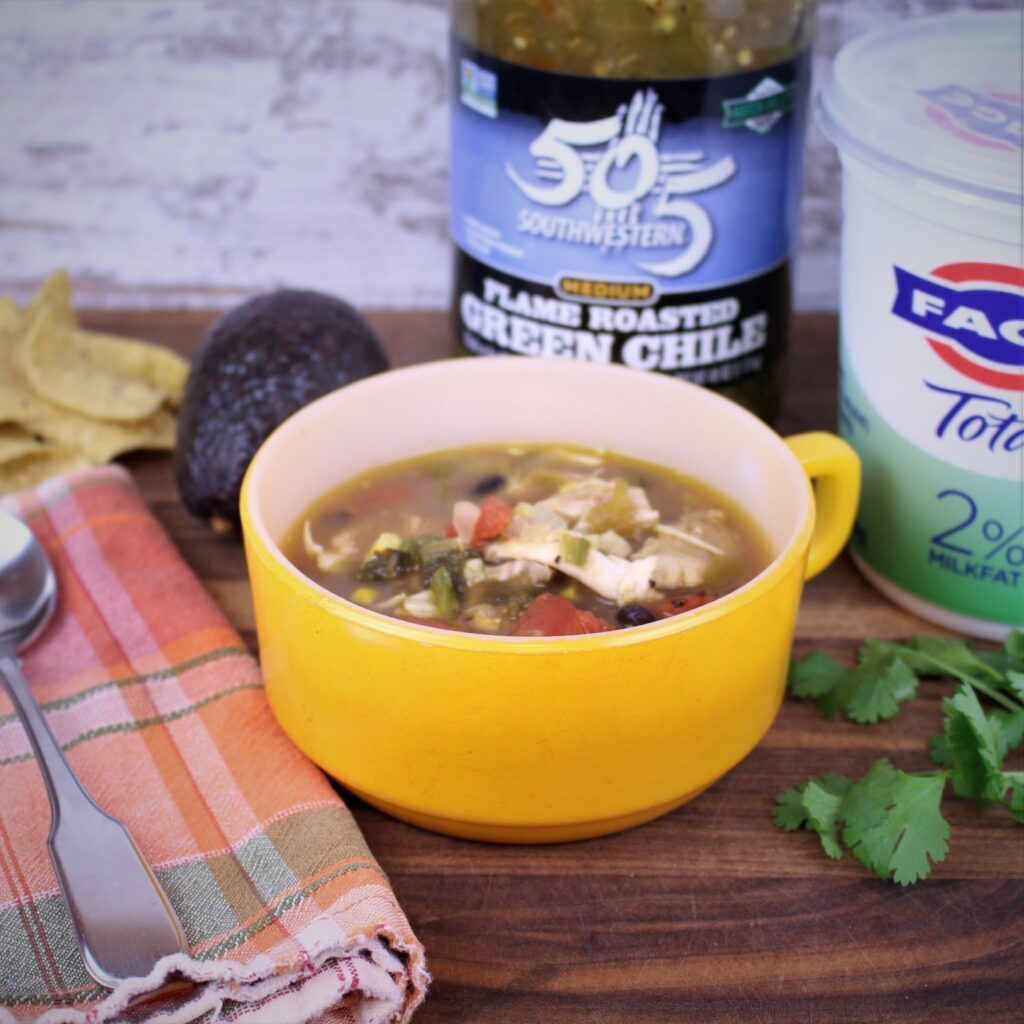 Easy Salsa Verde Chicken SOup is ready for it's topppings of plain Greek yourt, tortilla chips, avocado, and cilantro