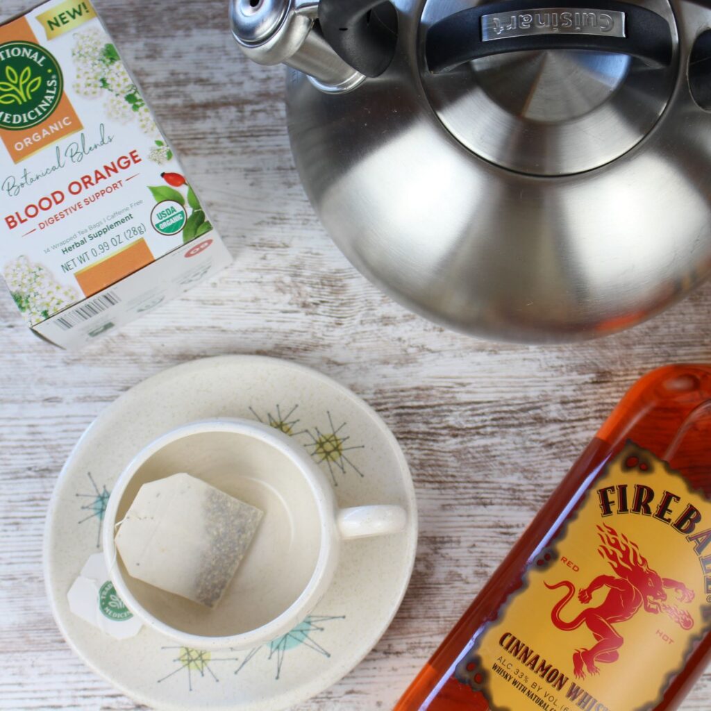 teapot, tea cup, fireball cinnamon whiskey and herbal tea is what you need to make this hot tea totty