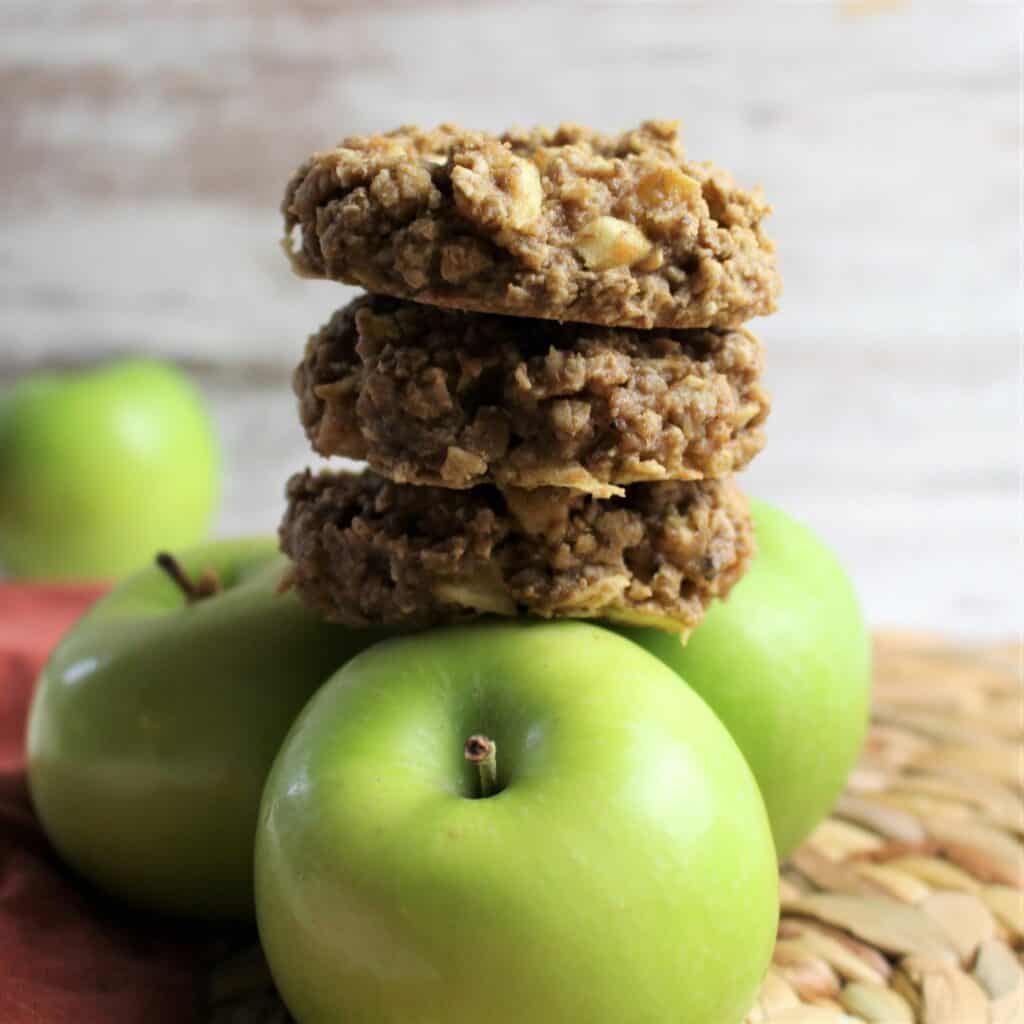 apple peanut butter breakfast cookies stacekd on top of granny smith apples