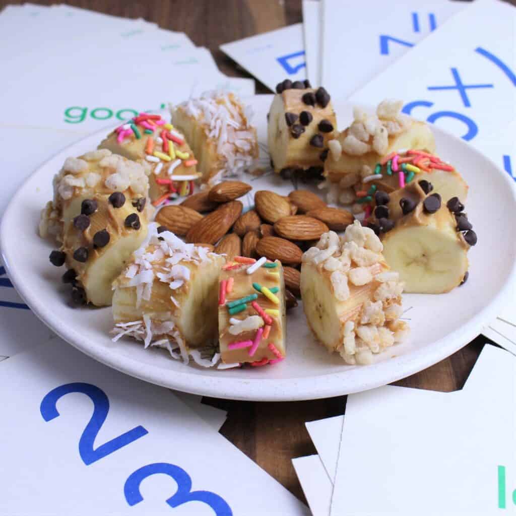 banana sushi is a banana covered in peanut butter, sprinkled in toppings and cut into bite size pieces.