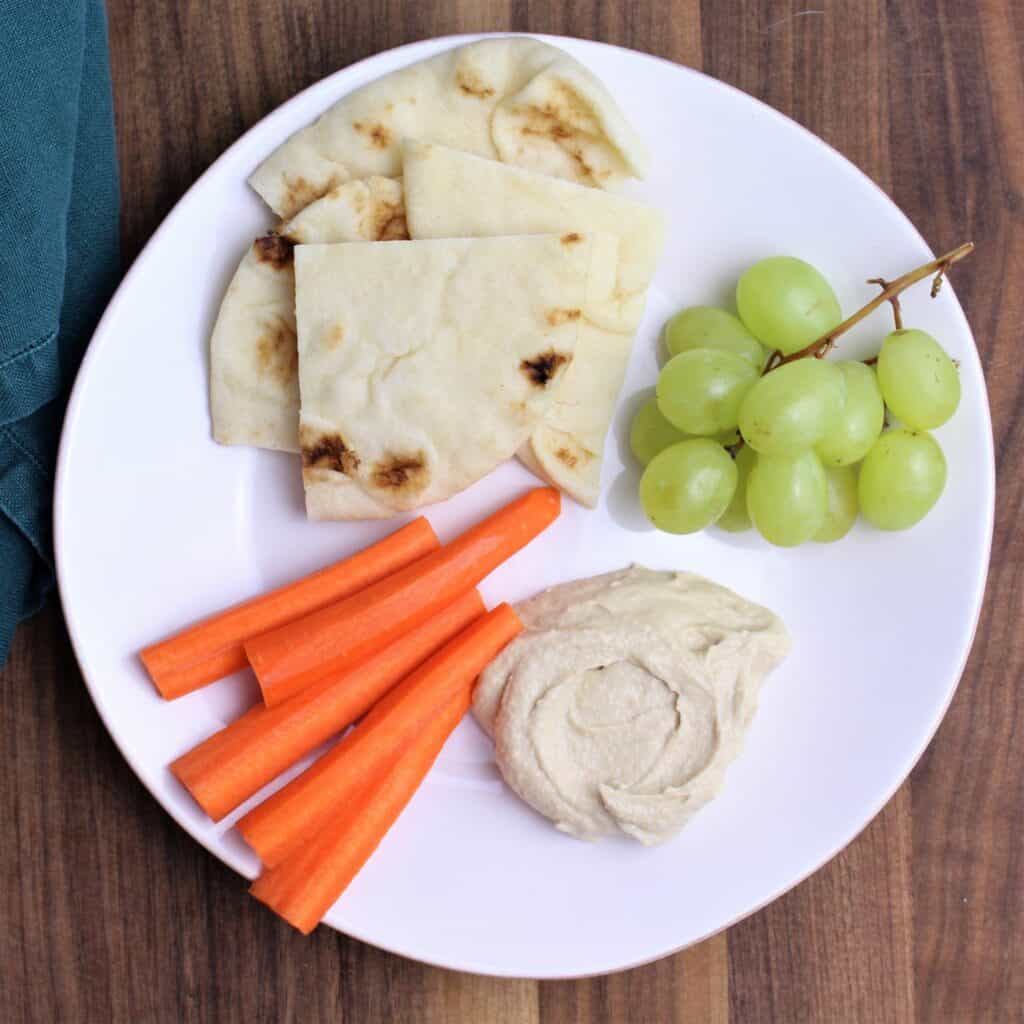 naan, carrot sticks, grapes and hummus make a perfect after school snack