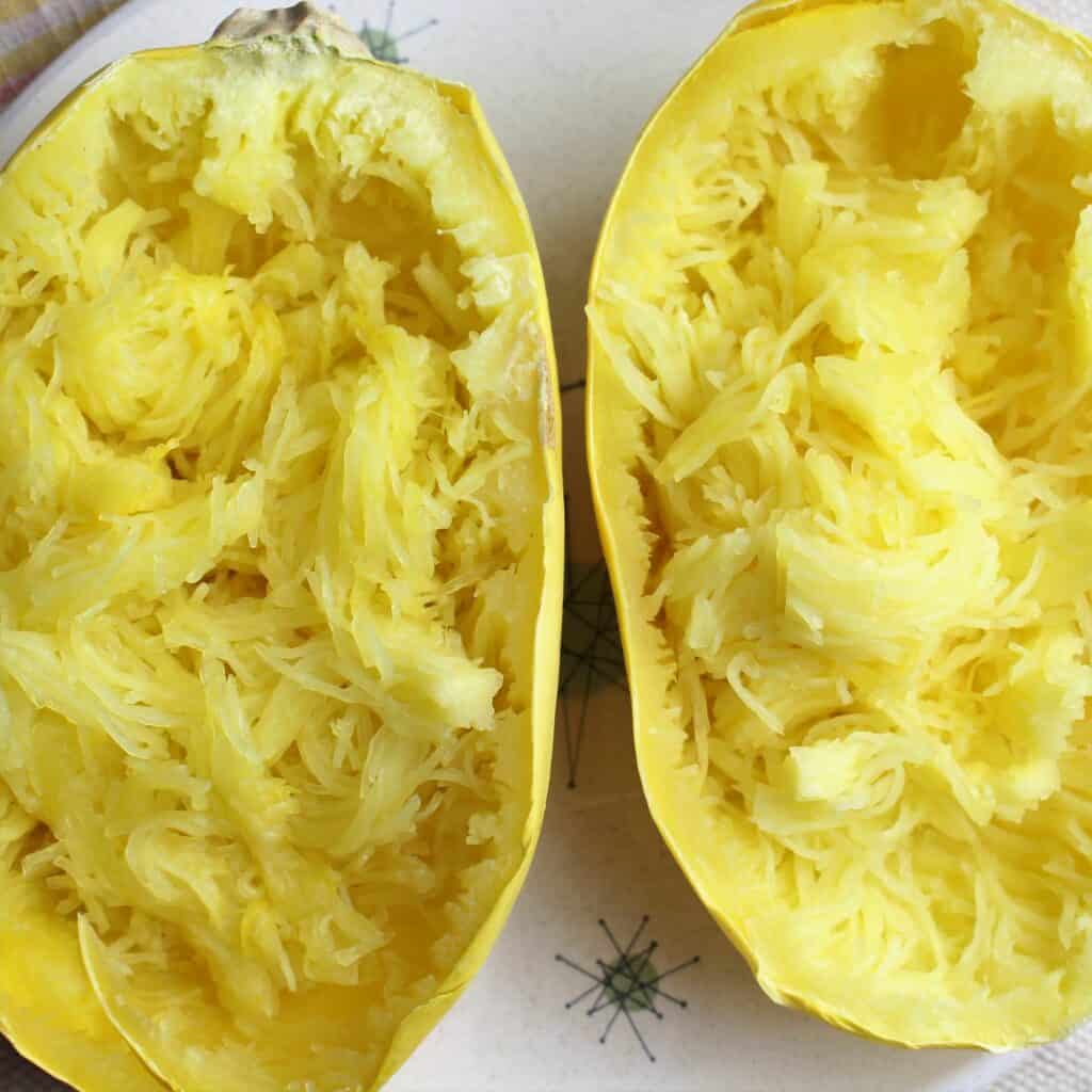 spaghetti squash halves filled with shredded strands