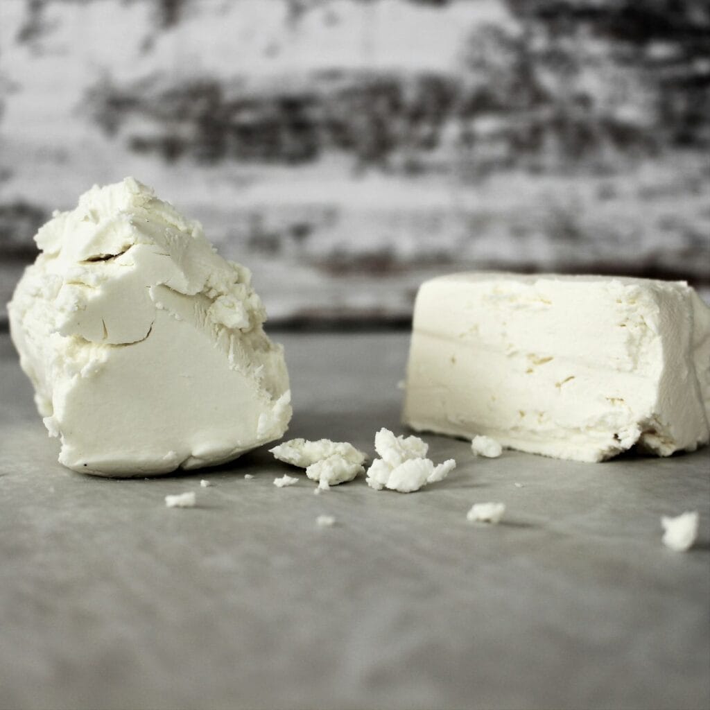 Goat cheese and cream cheese next to each other.
