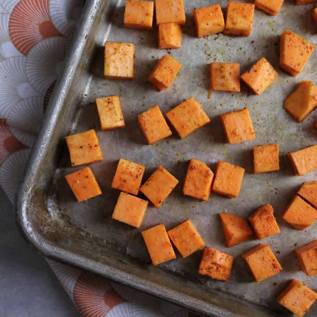 sweet potatoes with Harissa on a sheet pan ready for the oven.
