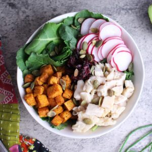 Sweet potato nourish bowl filled with a complex carb, protein, veggies, and healthy fats.