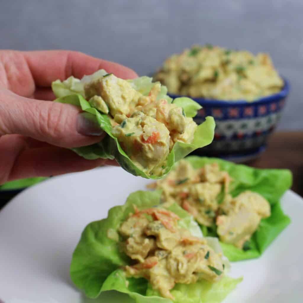 The perfect meal, butter lettuce cups with a scoop of healthy curry chicken salad in the middle.