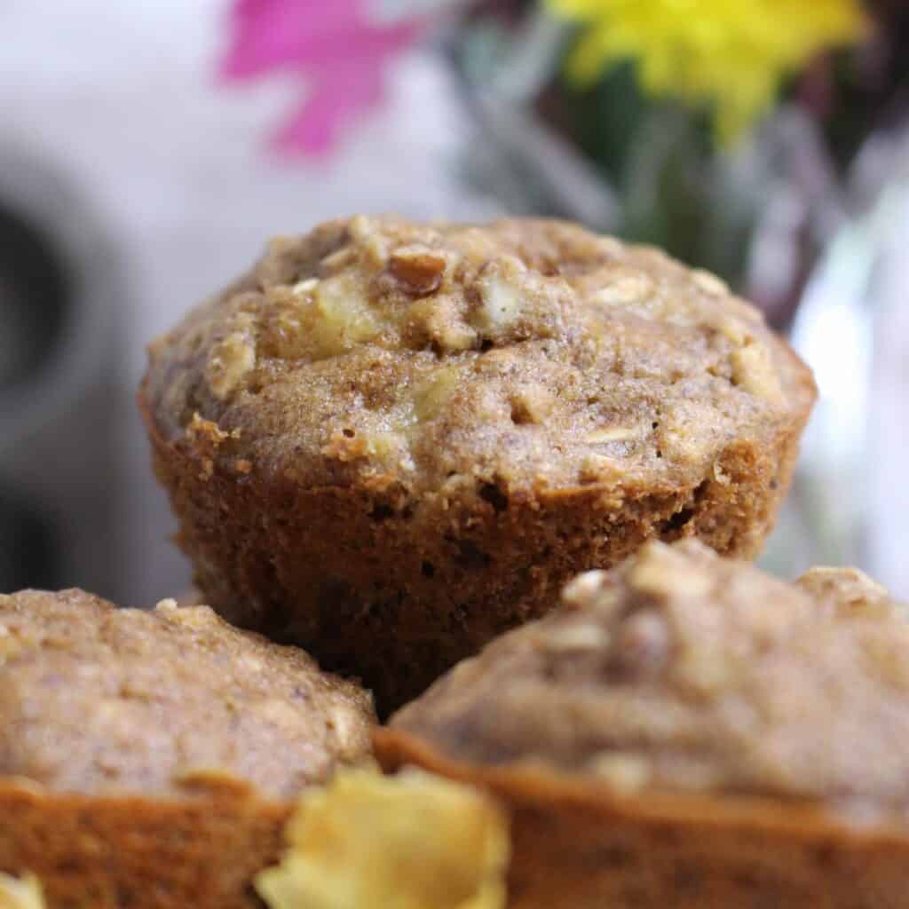 Close up of these Hummingbird Muffins which are full of pineapple, bananas, and pecans.