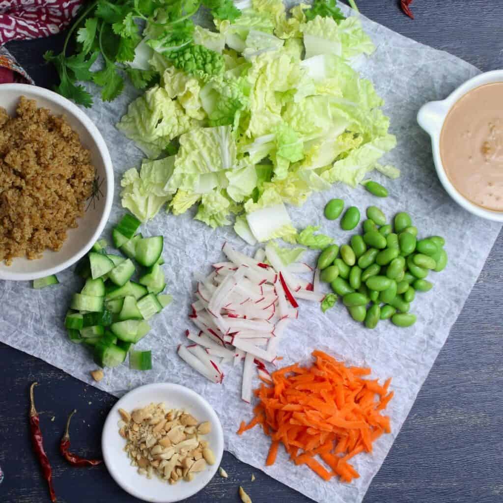 Fresh crunchy veggies, cooked quinoa, and prepared peanut sauce are the delicious ingredients you need to make this well-balanced Nourish Bowl.