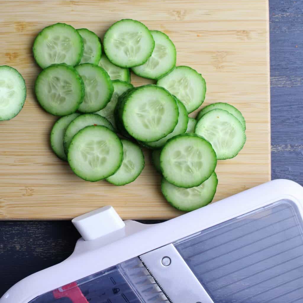 Cucumbers sliced on a mandoline.