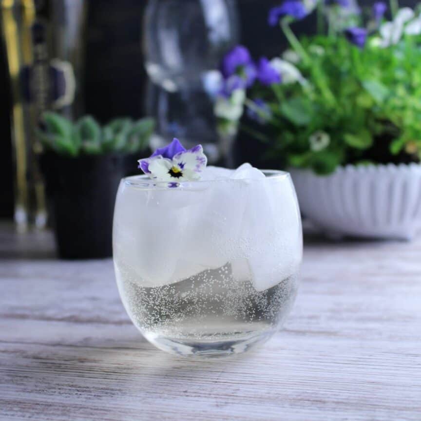 St. Germain, seltzer water, and ice make a delicious summer sipper in a stemless wine glass.