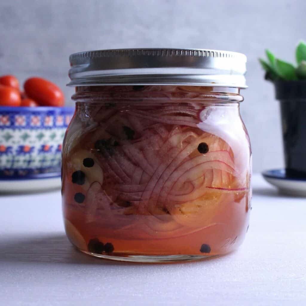 Quick pickled onions in a mason jar with the lid on tight. 