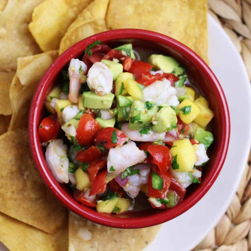 Fresh tomatoes, onions, jalapenos, cilantro, avocados, mangoes, and garlic make this delicious salsa that is mixed in with marinated shrimp.