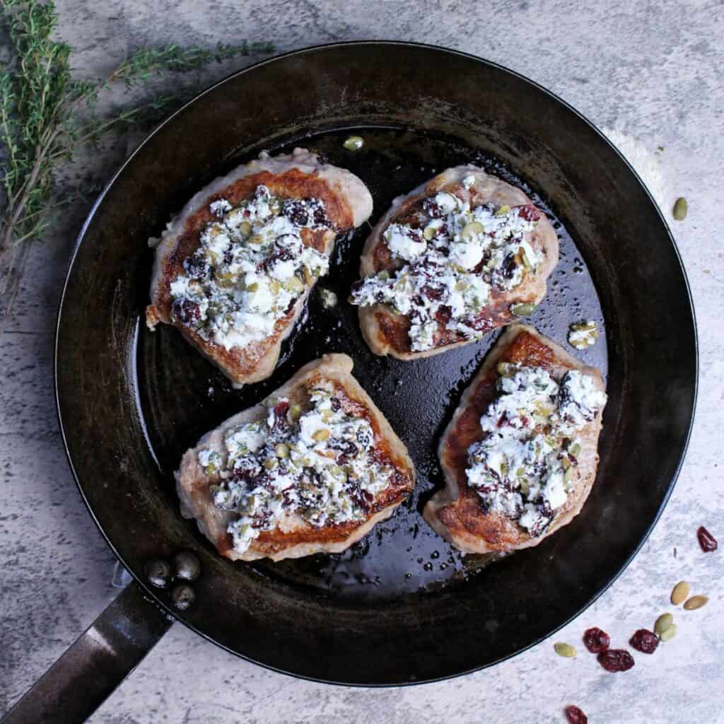 Seared pork chops topped with goat cheese cranberry crumble.