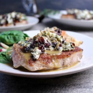 Pork loin chops topped with goat cheese, cranberries, and pumpkin seeds and a drizzle of Dijon pan sauce.