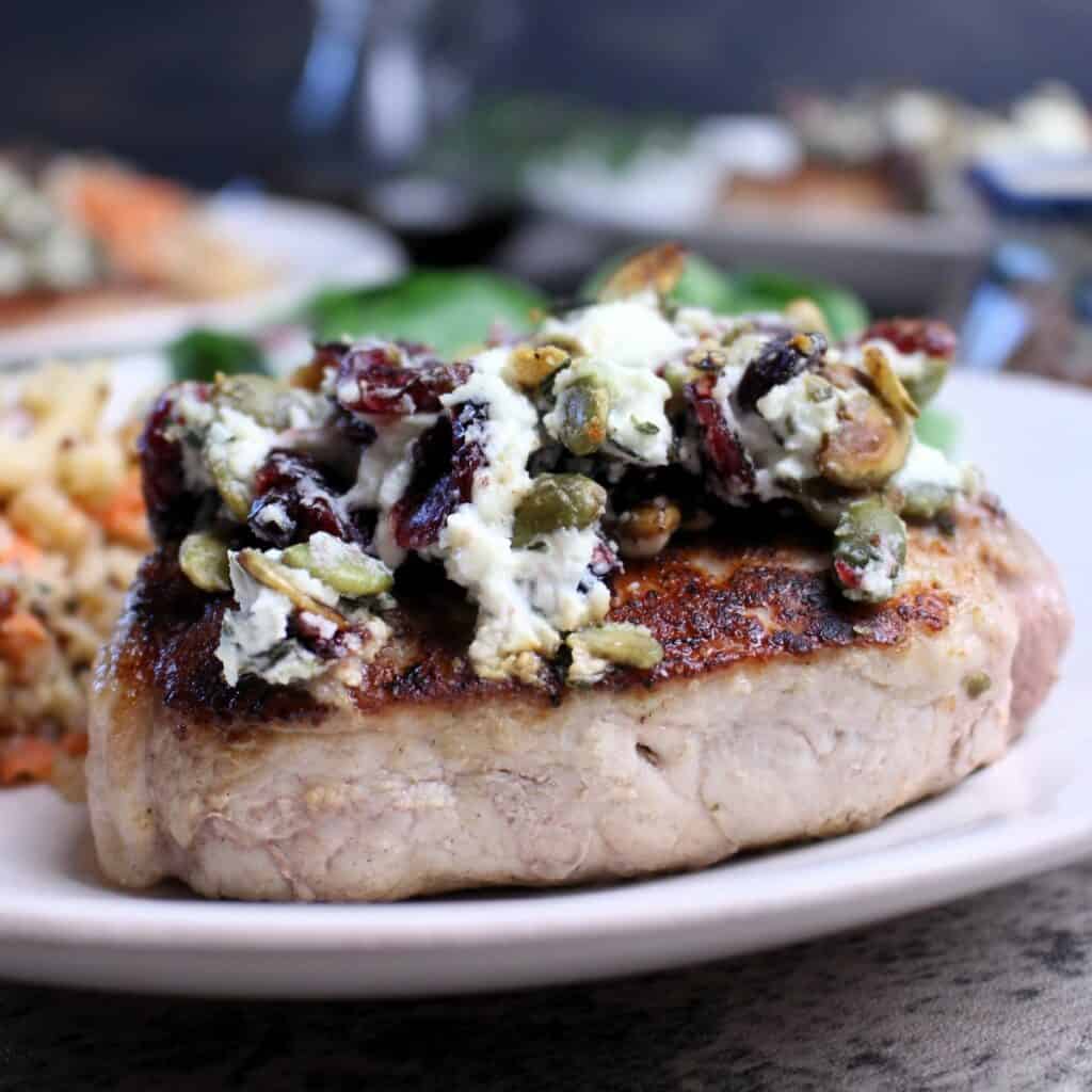 Pork loin chops seared to perfection and topped with goat cheese cranberry crumble.
