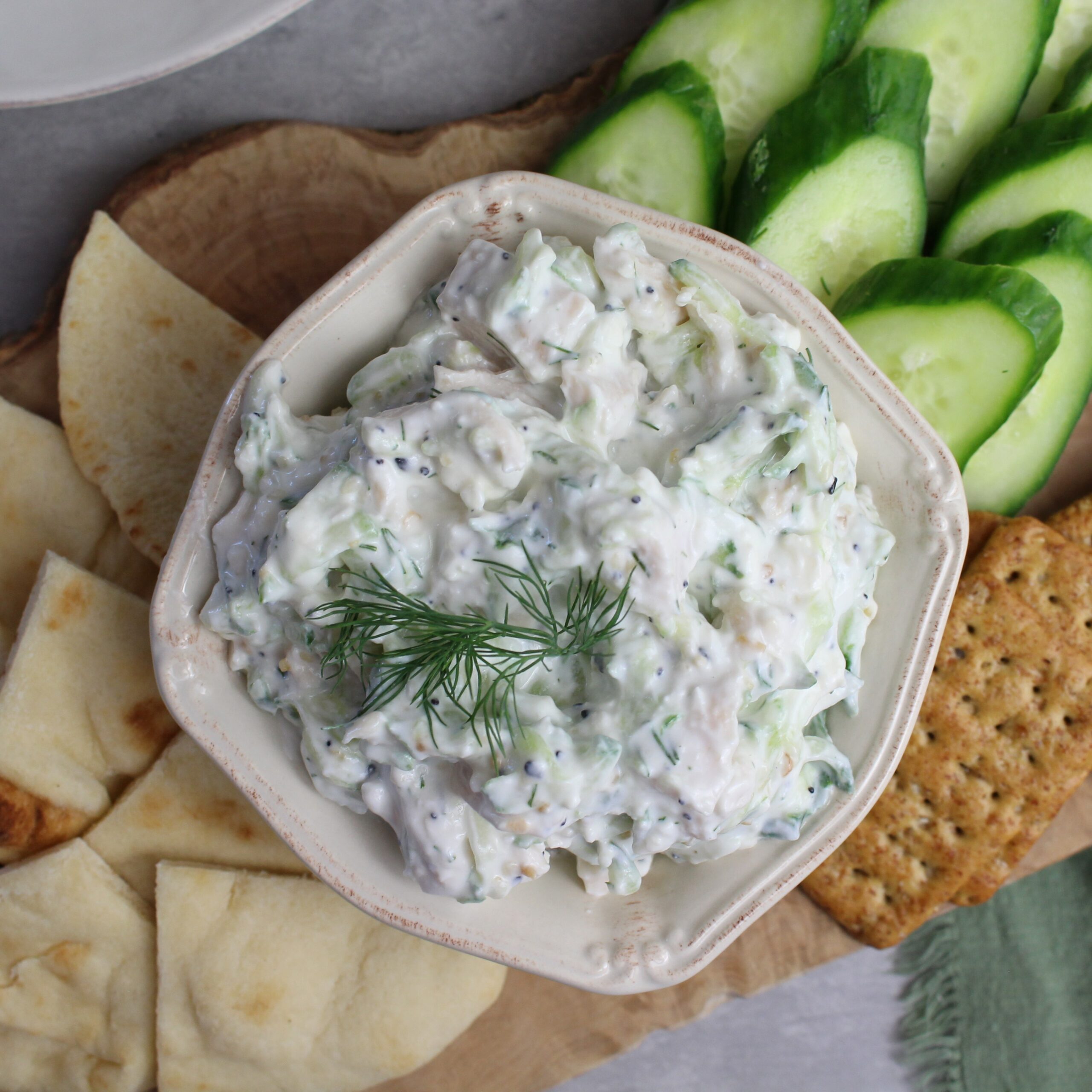 Chicken salad with tzatziki served with cucumbers, pita, and crackers.