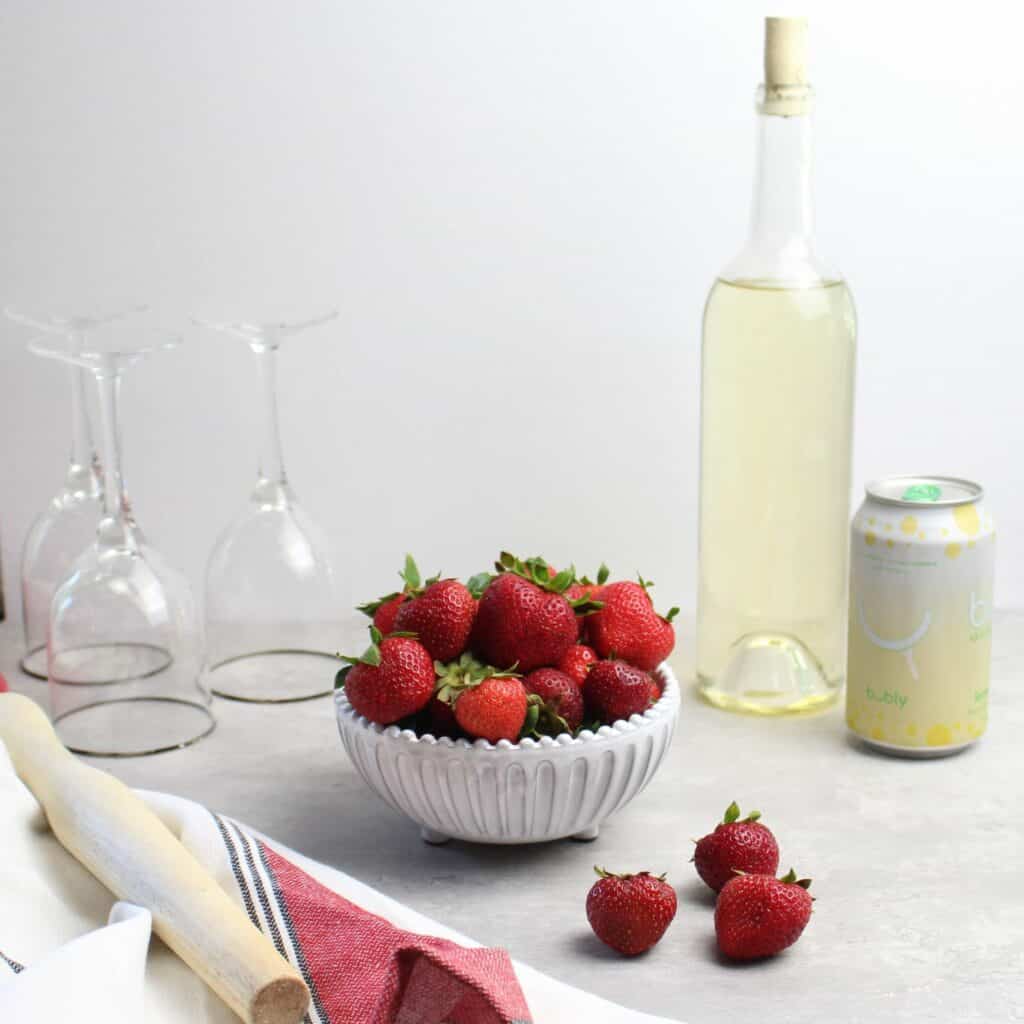 Strawberry Spritzer ingredients are fresh strawberries, white wine, and seltzer.