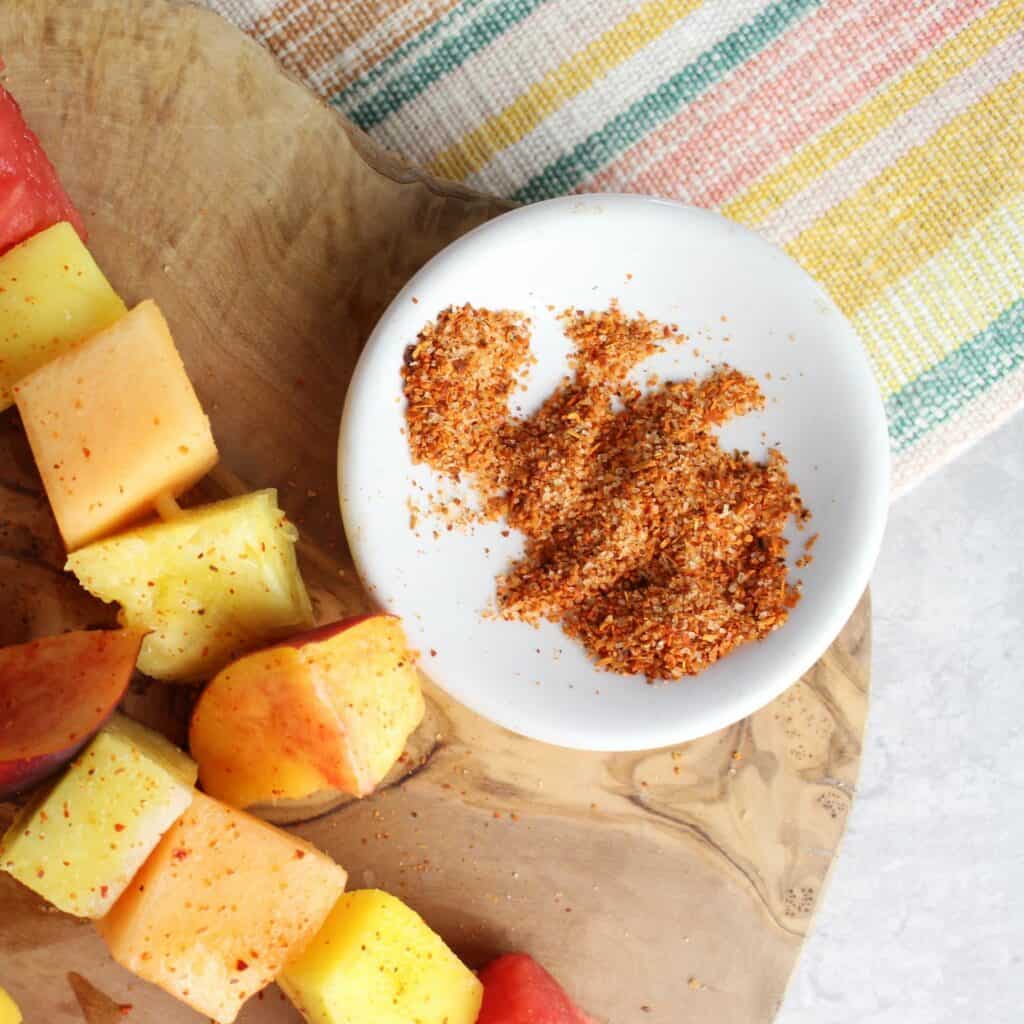 Tajin in a dish, just sprinkled on top of fresh fruit skewers.