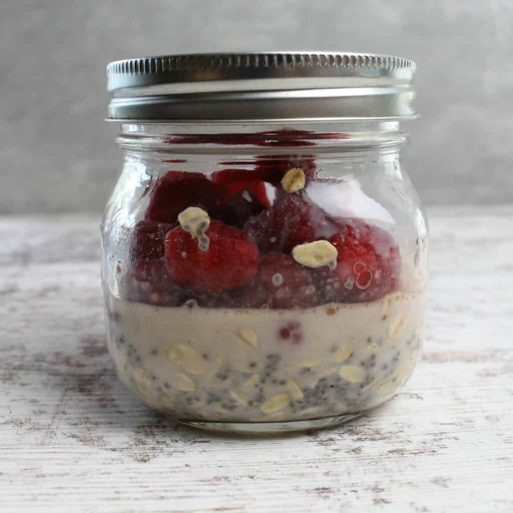 Mason jar just filled with overnight oat ingredients.