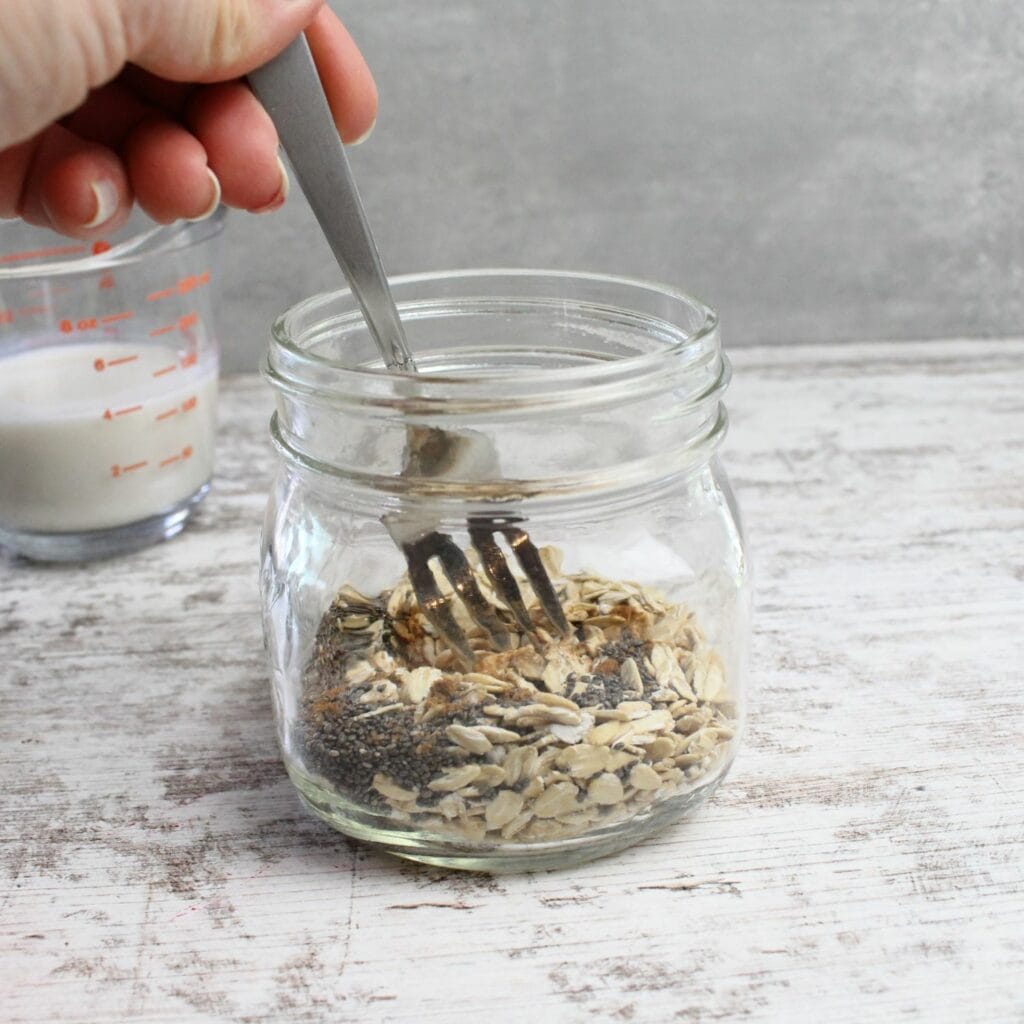 Prepare overnight oats by adding all dry ingredients to a glass jar and give it a stir.