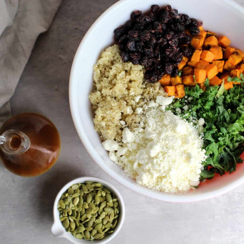 Autumn quinoa salad ingredients in a bowl before all mixed together.