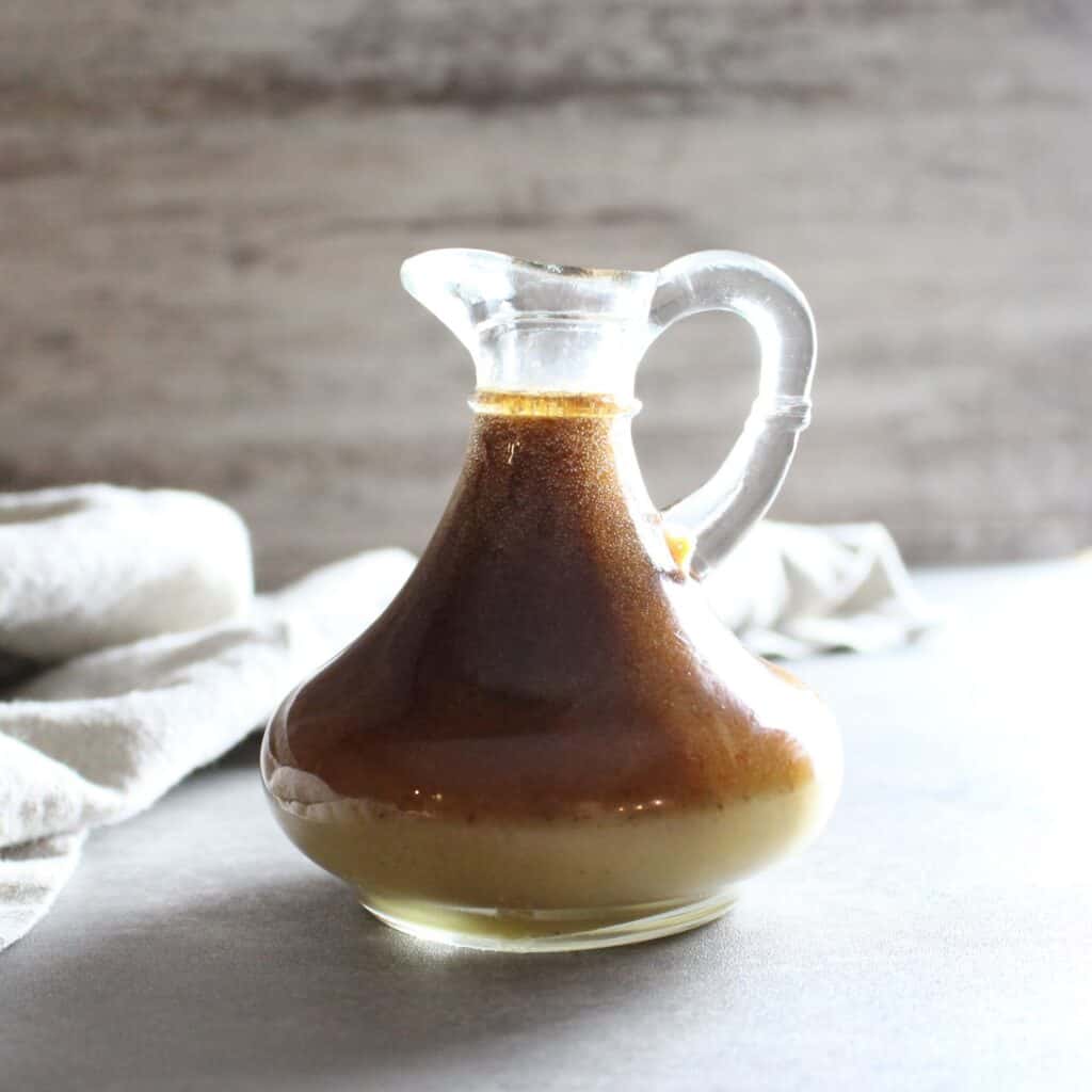 Glass carafe with cinnamon maple vinaigrette.