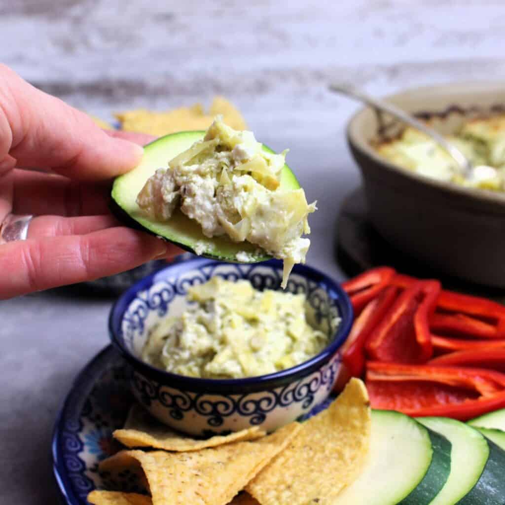 Round zucchini slice with dollop of artichoke pesto dip.