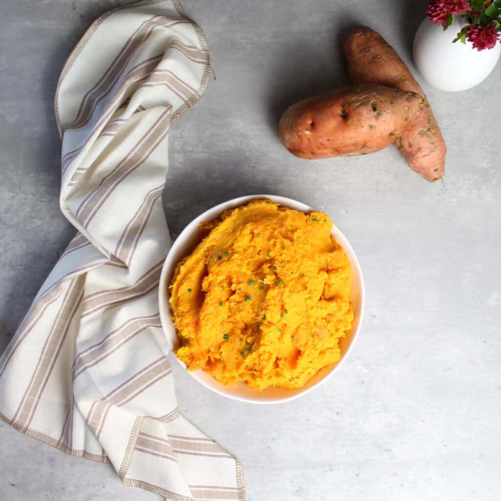 Sweet potato mash in bowl with napkin on side.