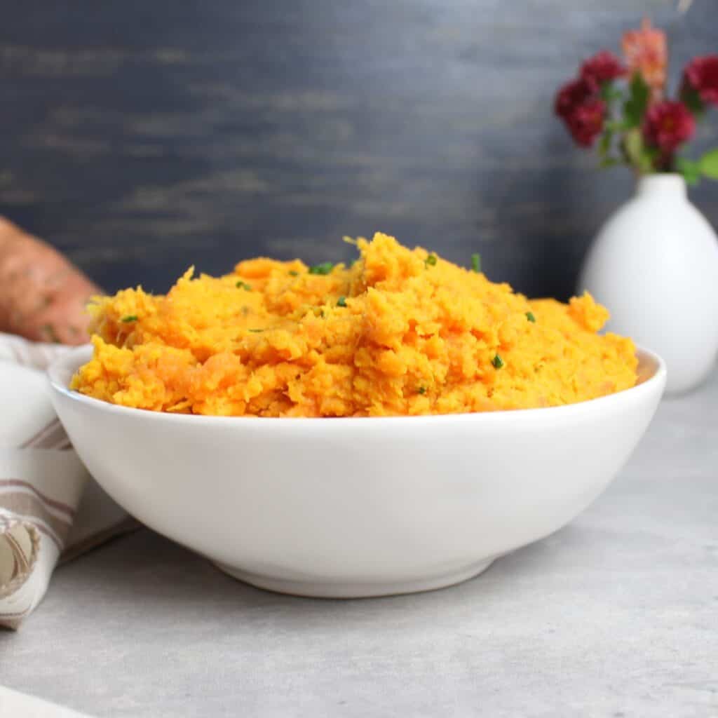 Sweet Potato Mash being served in white bowl.