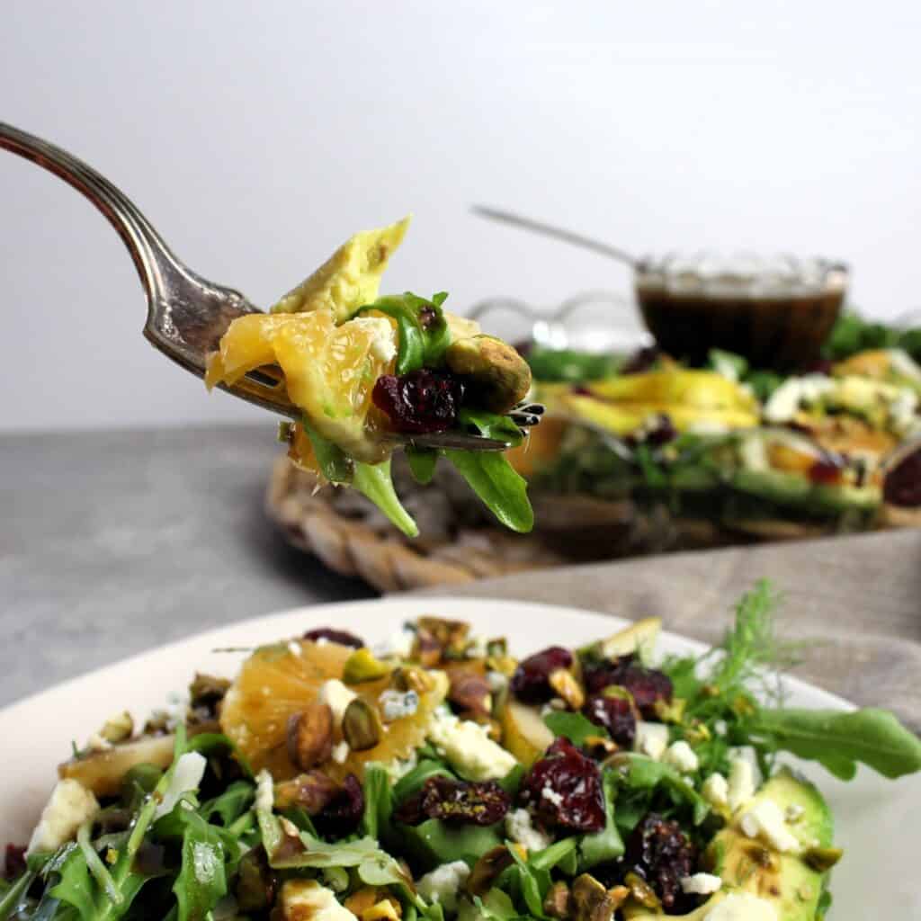 A forkful of pear arugula salad.