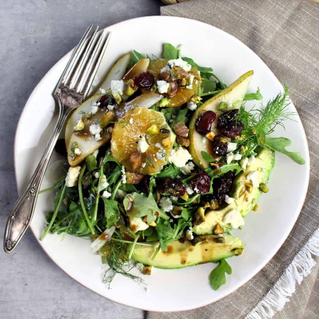 Pear Arugula Salad plated with fork.