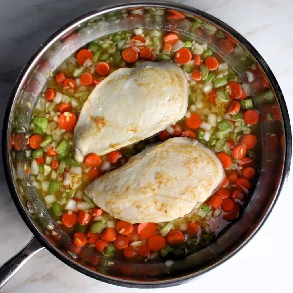 Pan of veggies, orzo, and chicken.